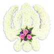 A large Sikh Khanda floral tribute is set against a spotless white background, its sacred form emerging entirely from a sea of white blossoms. The florist has used dozens upon dozens of small chrysanthemum heads, their soft petals pressed close together to trace the outline of the central khanda sword, the encircling chakkar, and the two outward-curving kirpans. This careful clustering of blooms gives the symbol a plush, cushioned look, almost like a white tapestry woven from petals. The colour is a gentle ivory white rather than stark, lending warmth and serenity. At the very base where the swords cross, a contrasting spray offers a delicate burst of colour: three pink roses, freshly opened with velvety, spiralled petals, rest amidst a ring of deep purple flowers and airy, bright green fern fronds. This accent draws the eye without overwhelming the purity of the main design, bringing a sense of human tenderness to the strong, iconic shape of the Khanda. The lighting appears soft and even, with only the lightest shadow below to hint at the tribute's three-dimensional depth. It is easy to imagine this arrangement prepared for a Sikh funeral or memorial gathering near Lea Bridge, perhaps travelling from a local workshop just off Lea Bridge Road to a family home or gurdwara where loved ones gather. The tribute feels considered and composed, blending spiritual symbolism with the gentle comfort of flowers, offering a quiet, dignified way to say goodbye and to honour a life with respect and love.