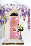 A tranquil new-home scene unfolds at this Lea Bridge entrance, where floral artistry and pastel paintwork meet. The door stands centre stage in a soft, powdery pink, its surface catching a gentle wash of daylight that makes the entrance appear inviting and calm, as if waiting for someone to cross the threshold for the first time. Overhead, generous cascades of wisteria in shades of lavender drape down in loose, tumbling strands, their blossoms forming a fragrant canopy against the whitewashed façade and a subtly painted shutter. The interplay of light and shadow through the trailing vines feels reminiscent of a quiet afternoon walk off Lea Bridge Road, when the sun falls low and kind. On the doorstep, a vintage-style grey bucket is positioned with care, overflowing with white and cream roses. Each rose is plump and velvety, surrounded by hints of soft green foliage that peek out between the blooms, adding texture and a garden-like freshness. A delicate pink ribbon encircles the bucket, tied into a gentle bow that mirrors the door's hue and introduces a touch of romance. The composition feels as if it has been crafted by a local Lea Bridge florist specifically to celebrate a move to a new address: understated yet full of feeling. The blend of pastel tones, natural textures, and filtered light creates an atmosphere that is both sheltered and optimistic, perfect for marking a housewarming, congratulating new homeowners, or simply honouring the quiet joy of arriving at a place that finally feels like home.