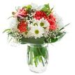 There's a bright, uplifting spirit woven into this bouquet-one that seems to catch the easy cheer of a weekend morning along Lea Bridge Road, where florists draw daily inspiration from their surroundings. At its heart, coral-hued carnations unfurl densely ruffled petals, their vibrant tones glowing warmly beneath even, natural light. Clusters of snow-white daisies and glossy chrysanthemum heads pop against this core, their rounded shapes and fresh green eyes radiating purity and a spark of youthful optimism, like the first buds in nearby Millfields Park come spring. Wisps of airy gypsophila-baby's breath-hover between larger blossoms, their tiny white florets adding a cloud-light delicacy. At the bouquet's edge, a glimpse of unopened alstroemeria buds offers hints of velvety magenta and promise for days ahead. Broad, lush green leaves wrap gracefully around the foot of the design, framing the whole with polished ease, while fine, darting foliage is artfully interlaced throughout for a just-gathered, organic finish. All elements are gathered in a simple, clear glass vase that reveals thick, vivid stems immersed in water-capturing that just-cut, local freshness ready for home delivery from Flowers Lea Bridge. Whether meant as a birthday surprise, a tender thank you, or simply a bright companion for a quiet afternoon at home in Lea Bridge, this bouquet brings a measure of nature's joy and a touch of neighbourhood warmth to any setting.